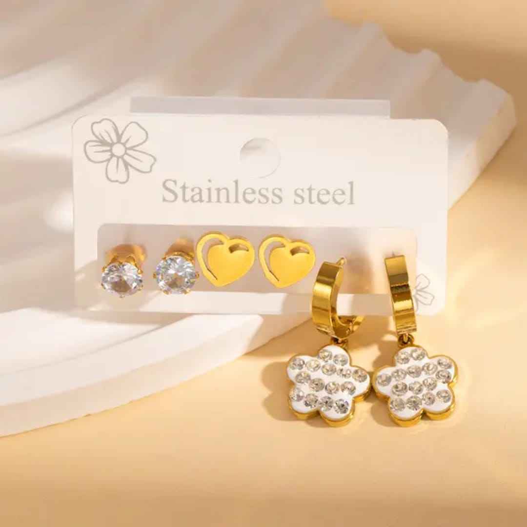 3-Pair Stainless Steel Earring Set: Gold Heart Studs, Crystal Solitaires, & White Floral Huggies